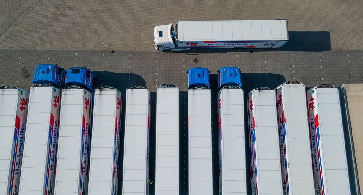 Freight trucks and trailers parked at a logistics distribution yard