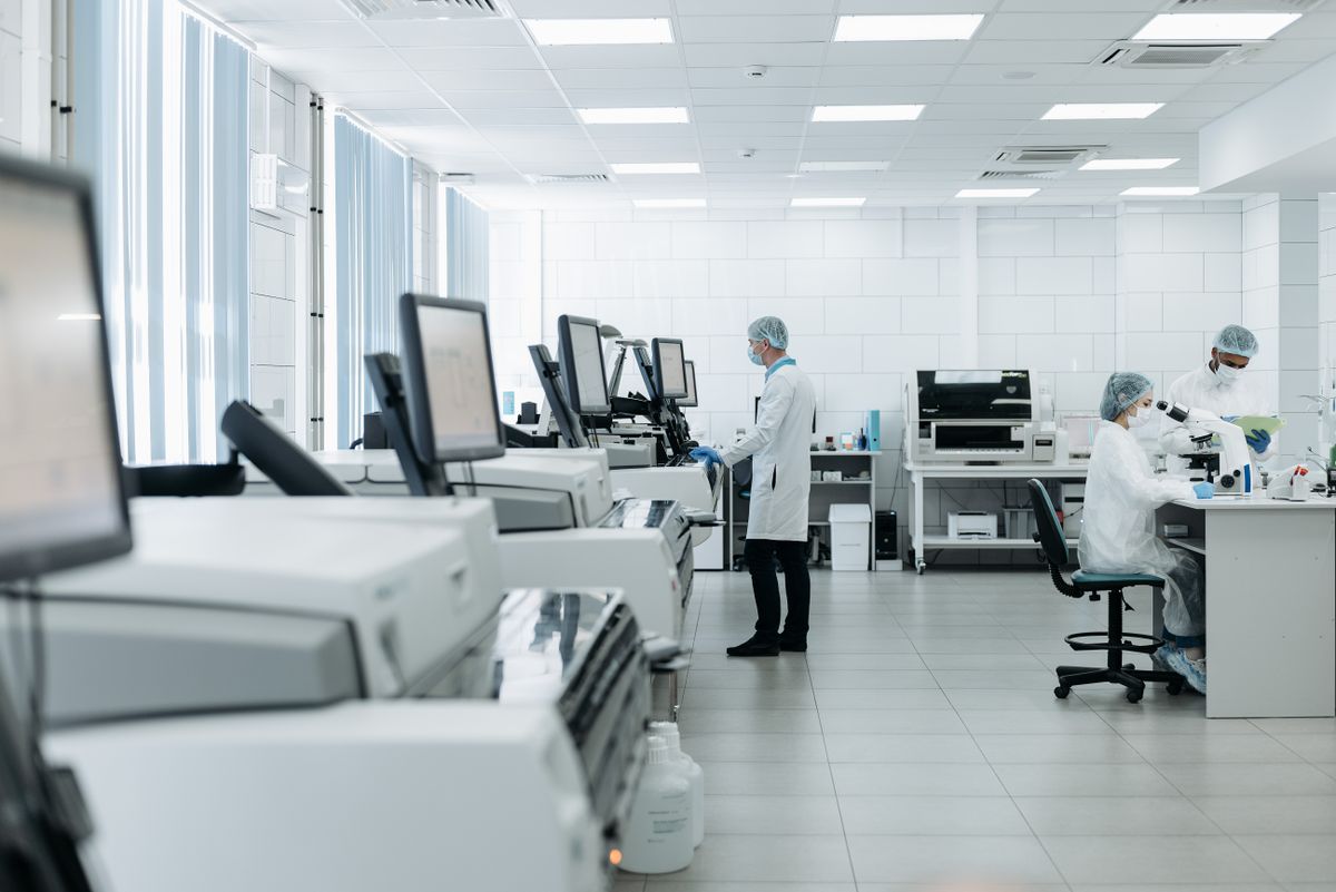 Researchers working with analytical equipment in a pharmaceutical laboratory